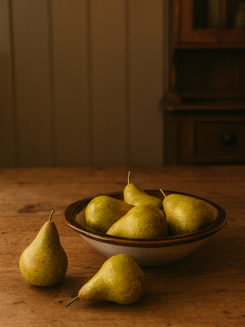 Bowl of pears on a wooden table with a neutral background