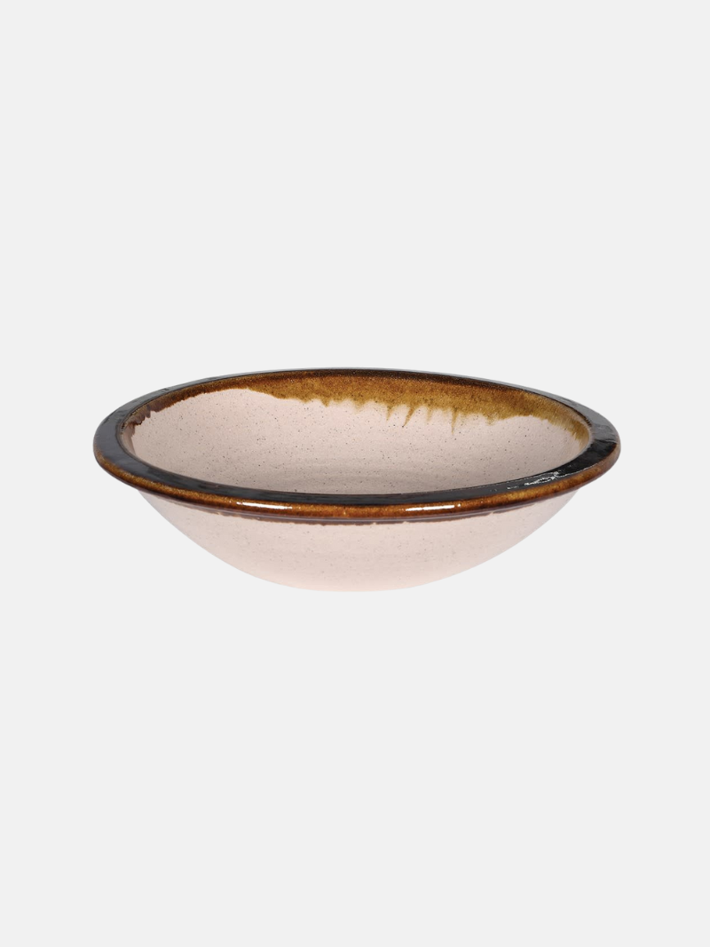 Ceramic bowl with brown rim on a white background