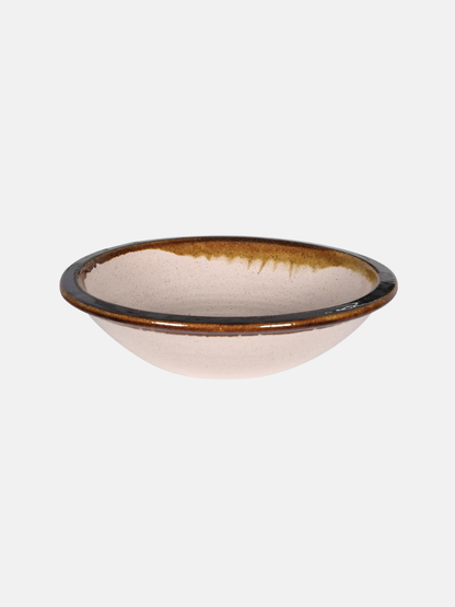 Ceramic bowl with brown rim on a white background