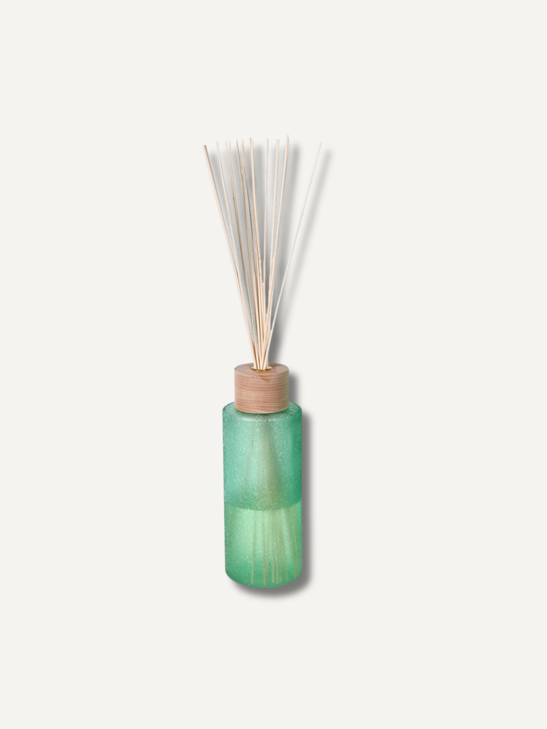Green diffuser bottle with wooden cap and reeds on a white background