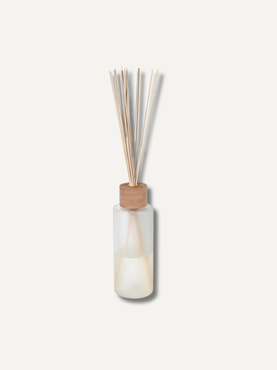 Reed diffuser with wooden sticks in a clear bottle on a light background