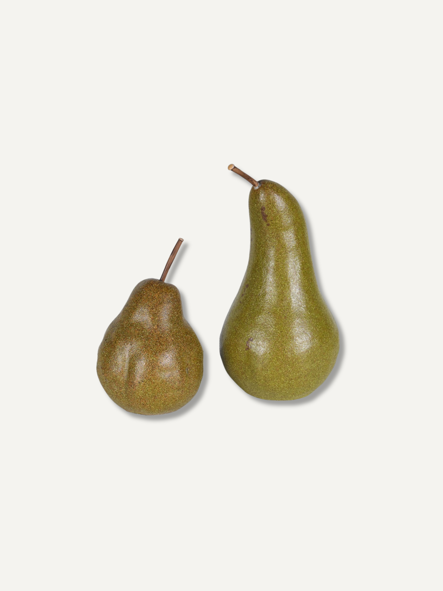Two decorative pears, one brown and one olive green, on a plain off-white background.