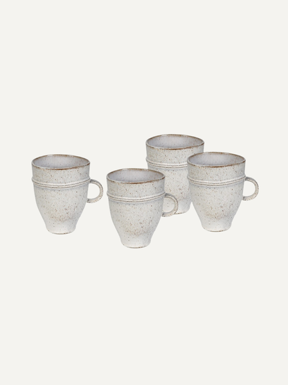 Set of four ceramic mugs with a textured finish on a white background