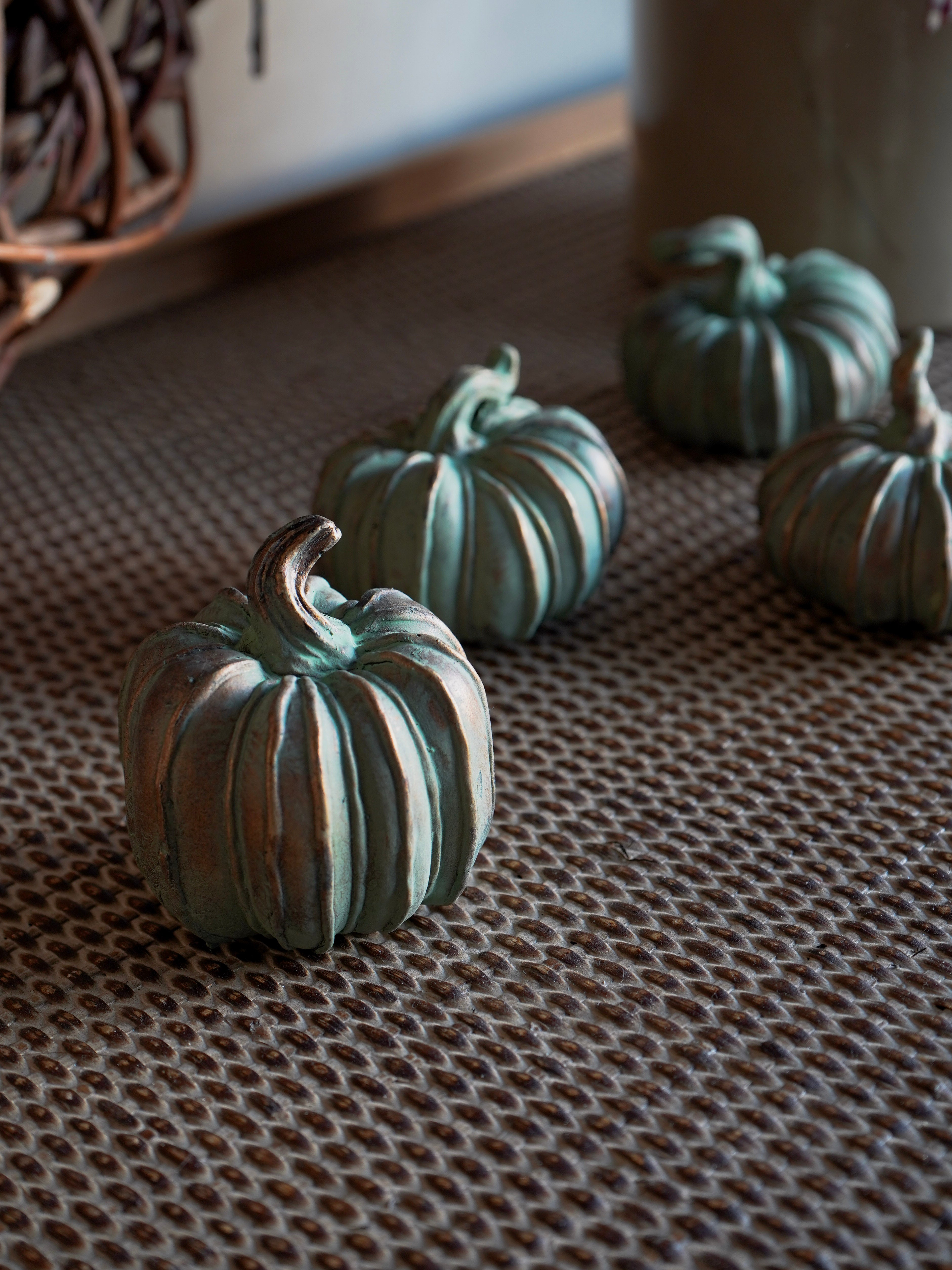 Decorative pumpkins on a textured surface