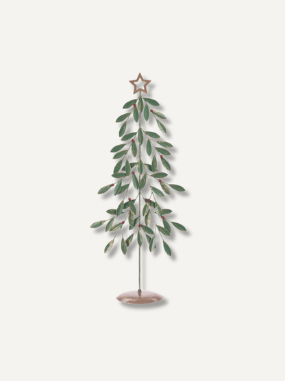 A decorative metal tree ornament with green leaves, a star topper, and a round base, shown against a plain light background.