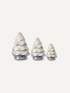 Three small christmas tree-shaped ceramic objects in graduated sizes, arranged from left to right on a plain light background.