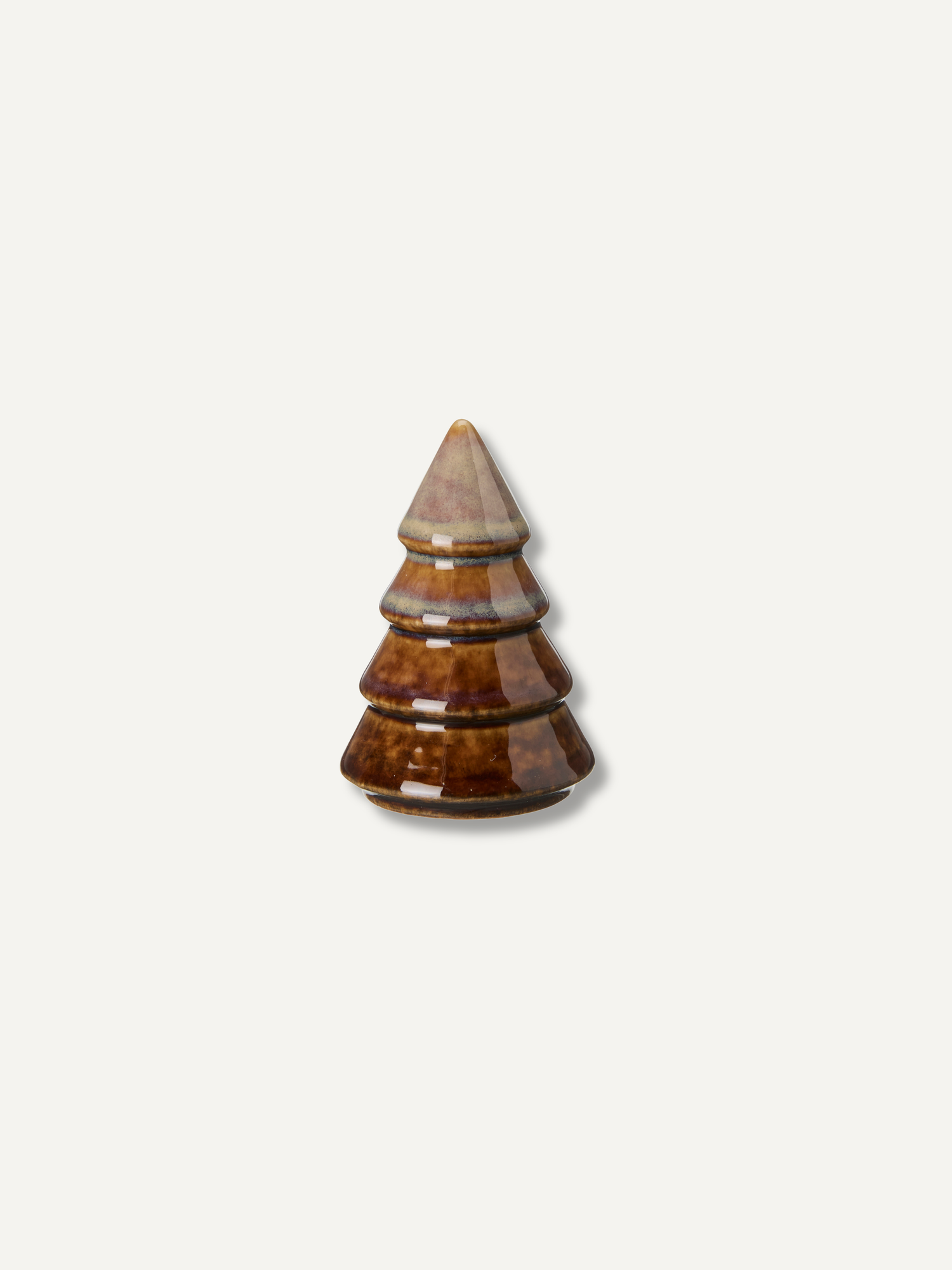 A small decorative christmas tree-shaped object with a glossy brown and amber marbled pattern and a light beige pointed top, centered on a plain off-white background.