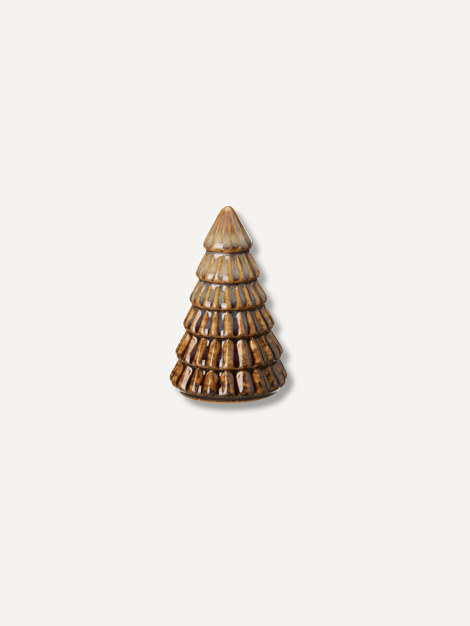 A small decorative ceramic Christmas tree ornament with a textured, ribbed design and a glossy brown and beige glaze, centered on a light off-white background.