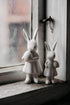 Set of white ceramic bunnies with easter egg