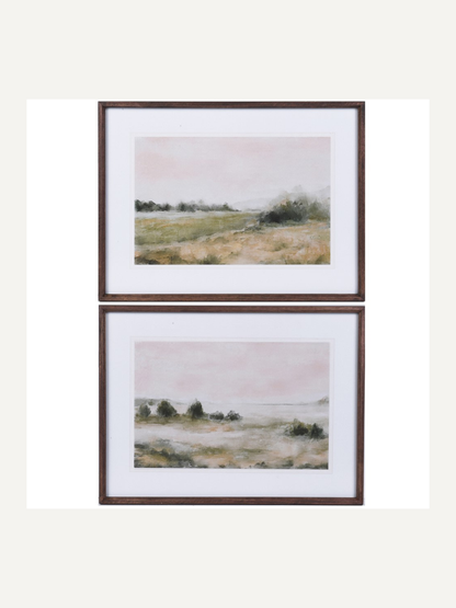 Two framed landscape prints of a shore line on a white background