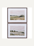 Two framed landscape prints of a shore line on a white background