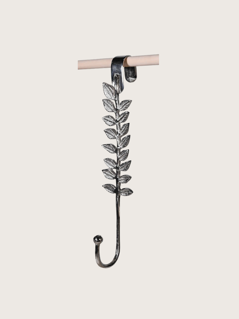 Decorative leaf-patterned wreath hanger hook on a white background