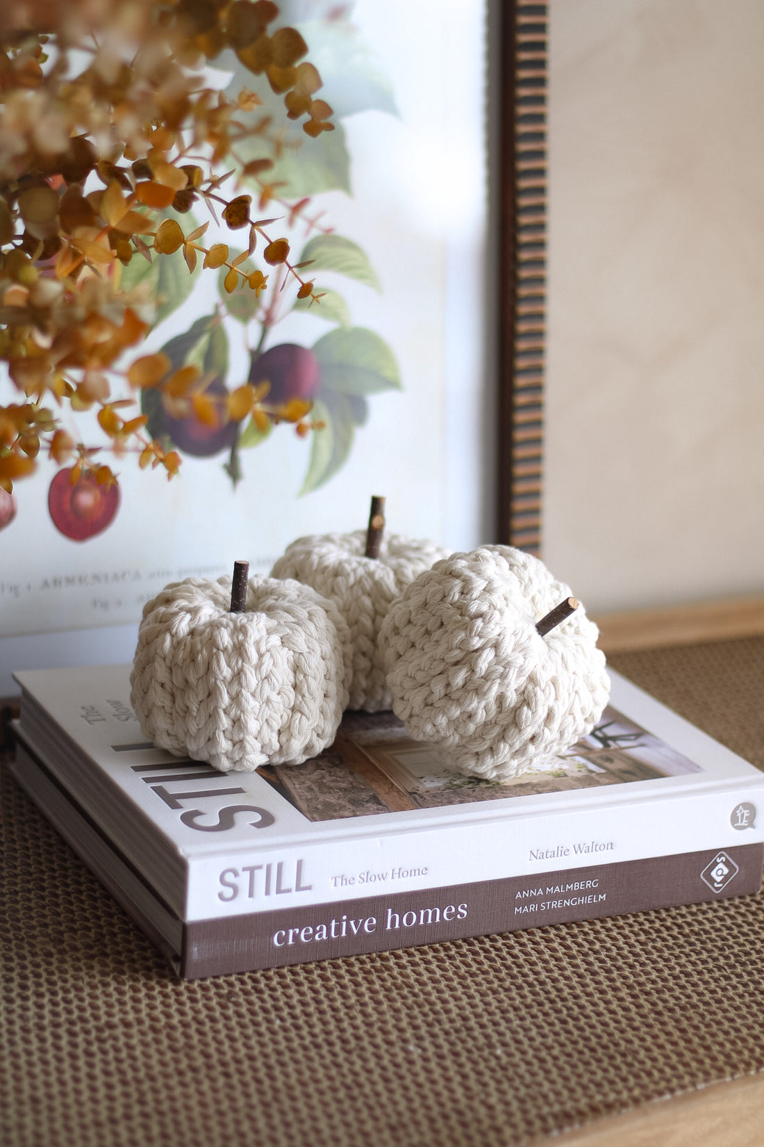 Knitted pumpkins on a book titled &