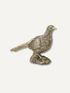 A small metallic bird figurine with a textured, scale-like surface, standing on a matching base against a plain light background.
