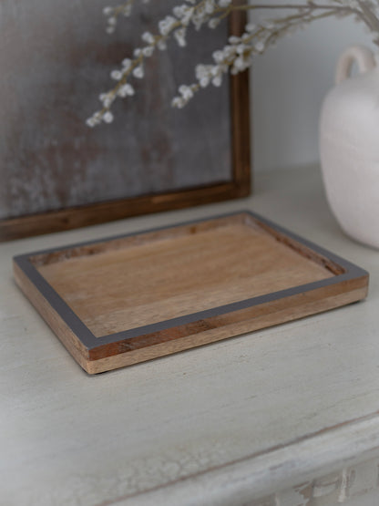 Wooden tray on a white surface with a blurred background