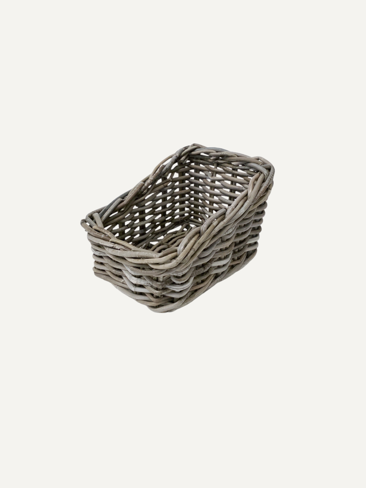 A small rectangular woven basket made from gray wicker or rattan, shown on a plain light gray background.