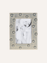 Decorative  grey ceramic dotty photo frame with a white background