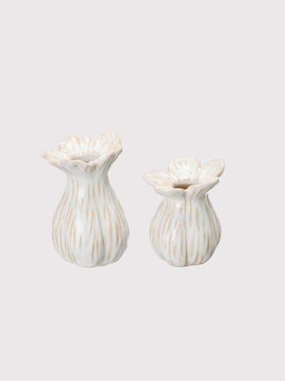 Two white ceramic bud vases with textured design on a light gray background