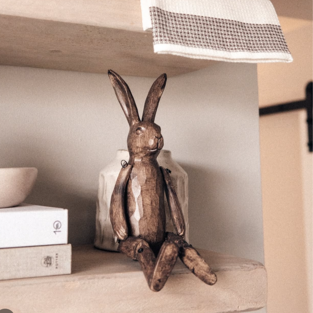 Brown seated rabbit ornament on shelf decoration