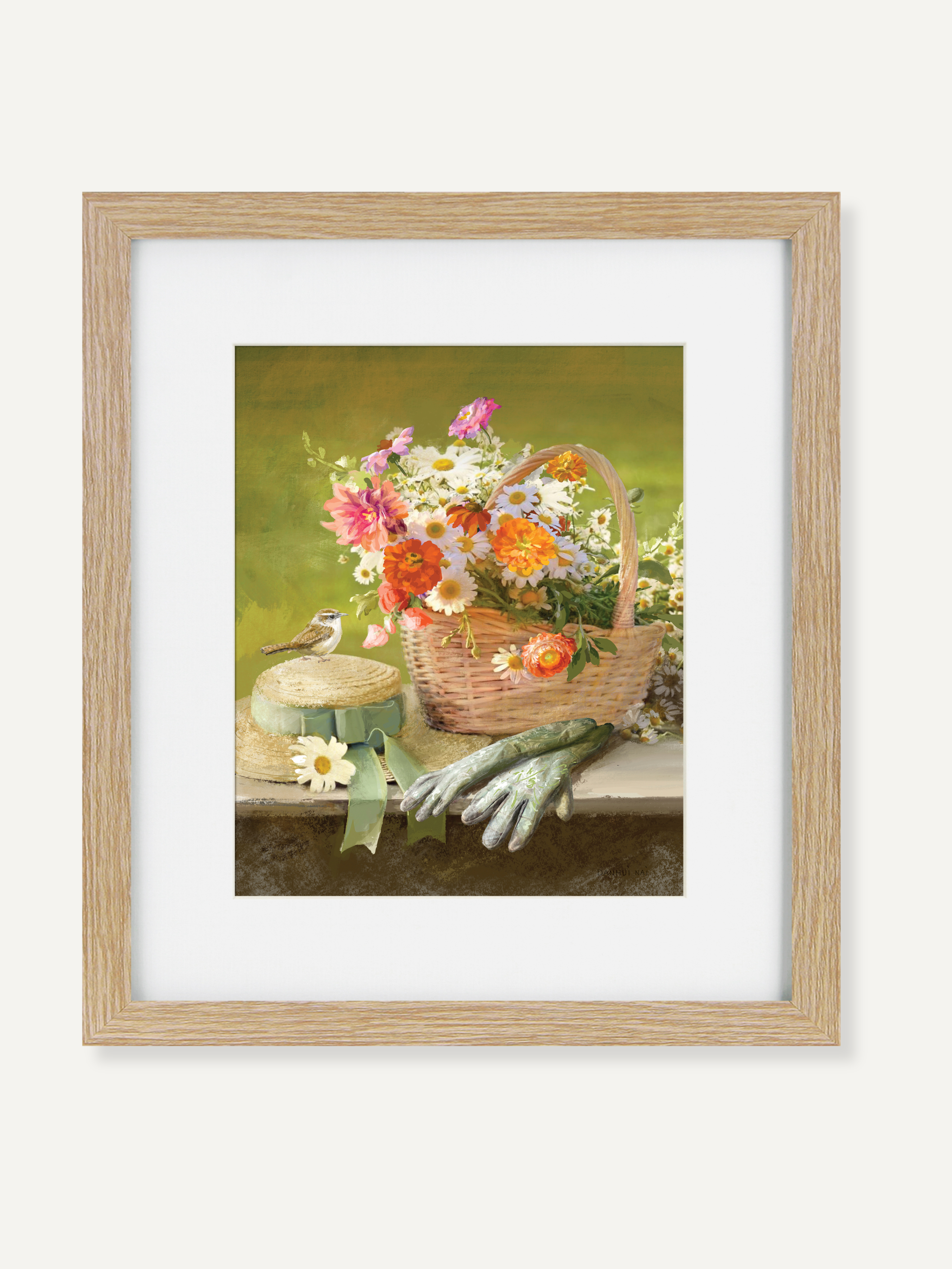 Framed artwork of a floral basket with gardening tools on a table.