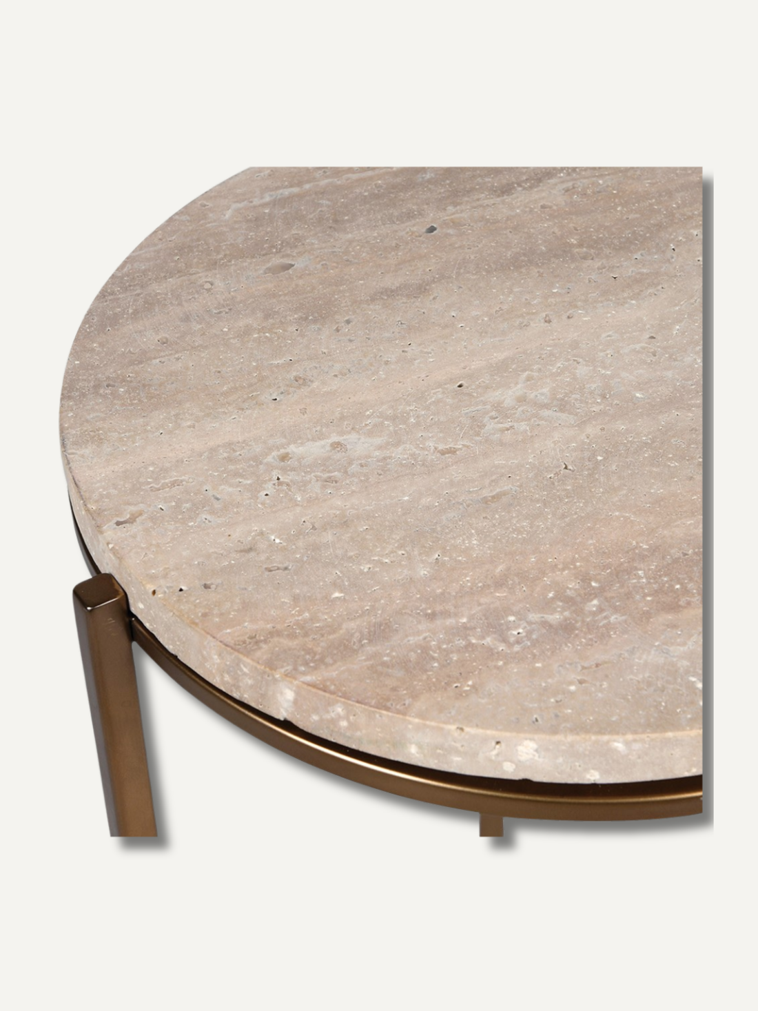 Round travertine table with bronze base on a white background
