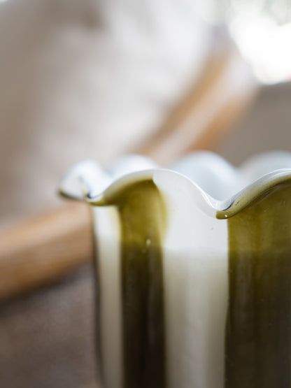 Up close of Tuberose Scented Scallop Edge Olive Stripe Candle