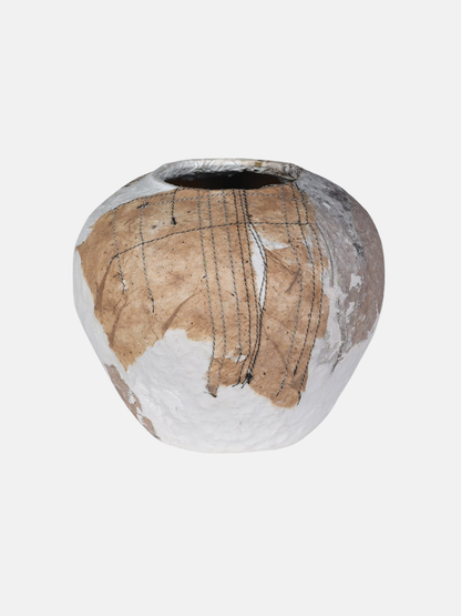 Ceramic vase with textured surface on a white background