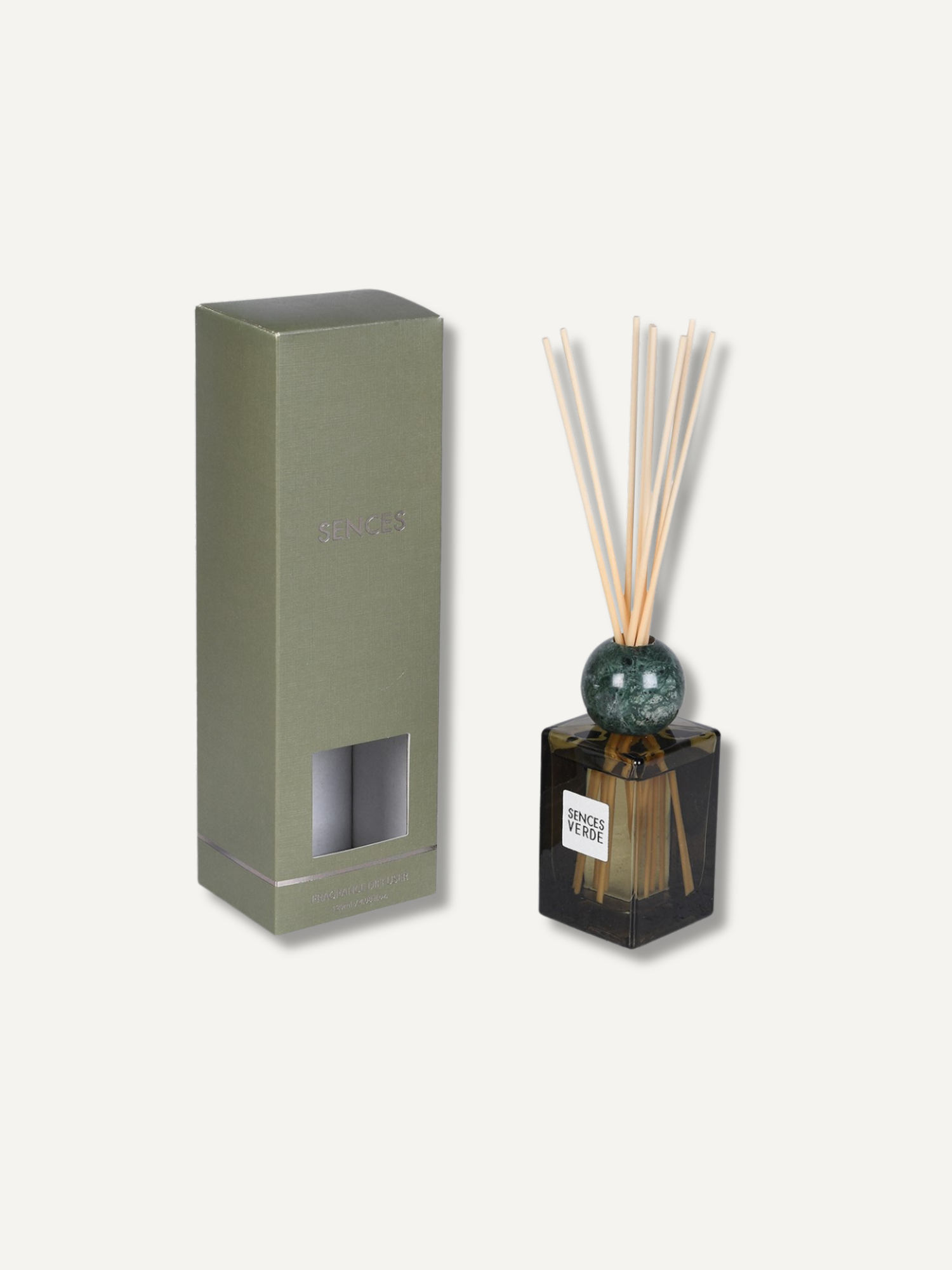 A reed diffuser set with a dark glass bottle, green marble sphere, natural reeds, and its matching olive green packaging box on a light beige background.