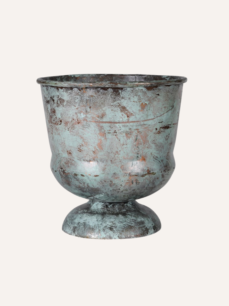 Vintage-style metal planter with patina finish on a white background