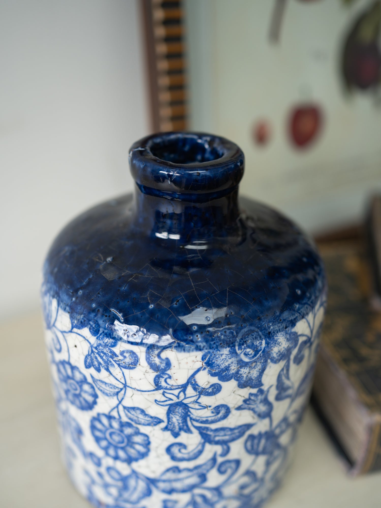 Blue and white ceramic vase with floral patterns on a blurred background
