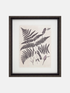 Framed artwork with fern leaves on a beige background