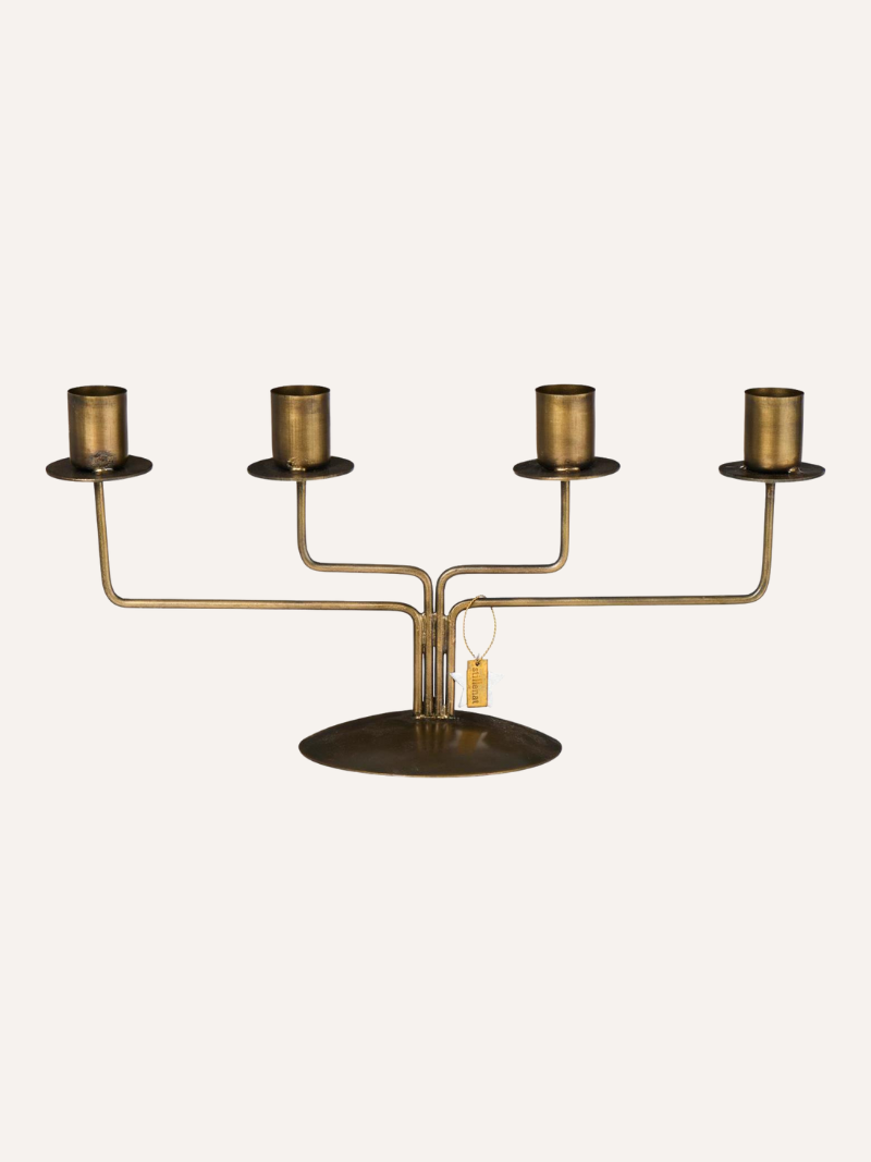 Brass candelabra with four candle holders on a white background