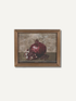 A framed still life painting of a pomegranate, featuring a whole and halved pomegranate on a dark surface against a textured beige-brown background, enclosed in a gold-toned frame.