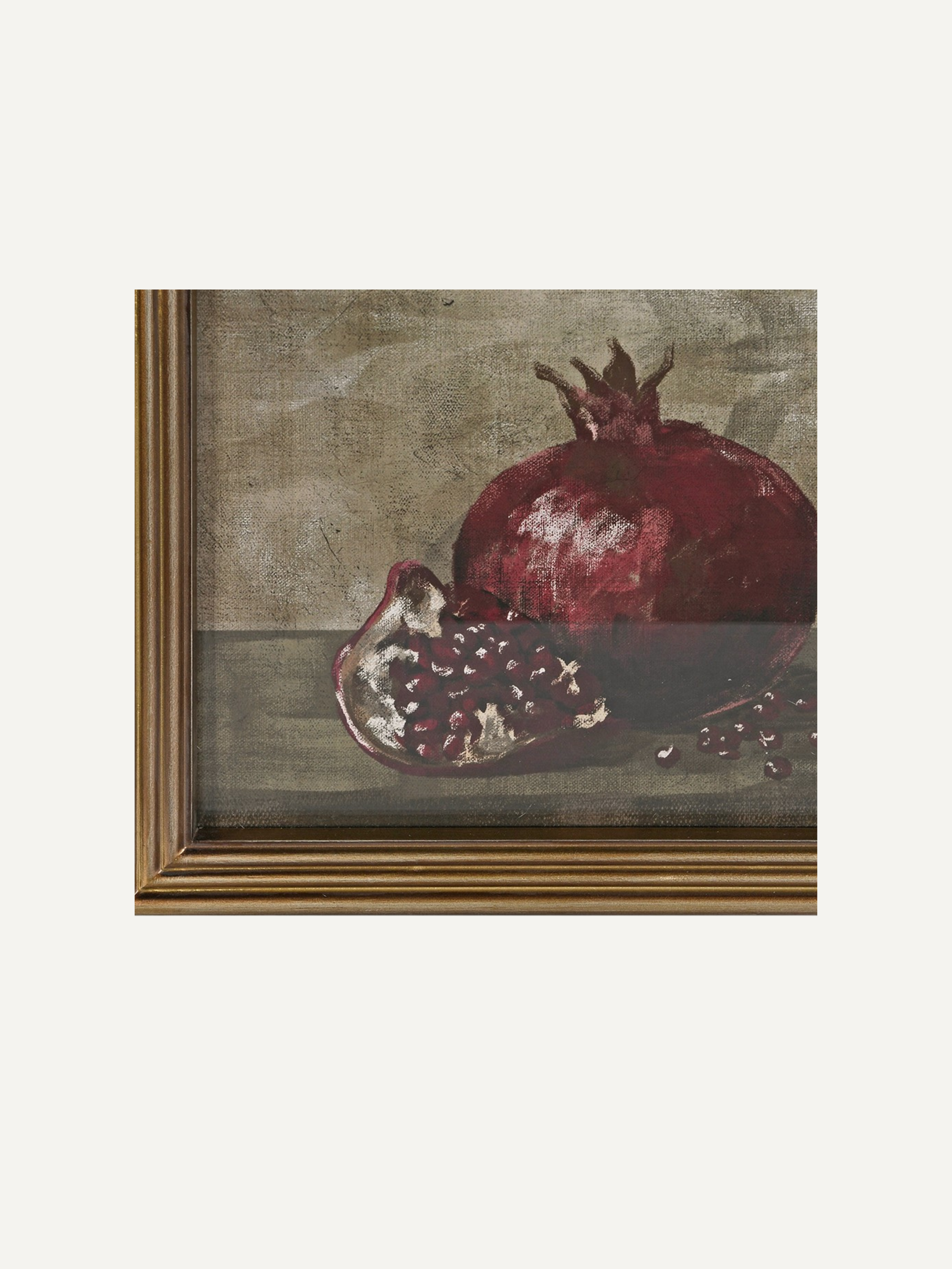 A framed still life painting depicting a whole and halved pomegranate on a muted textured background, shown against a light off-white backdrop.