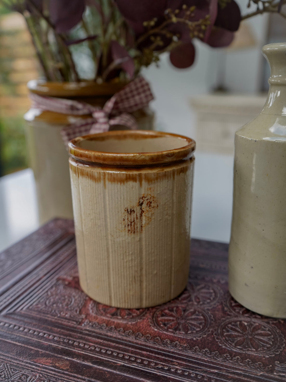 Ceramic jar with a textured surface on a patterned surface