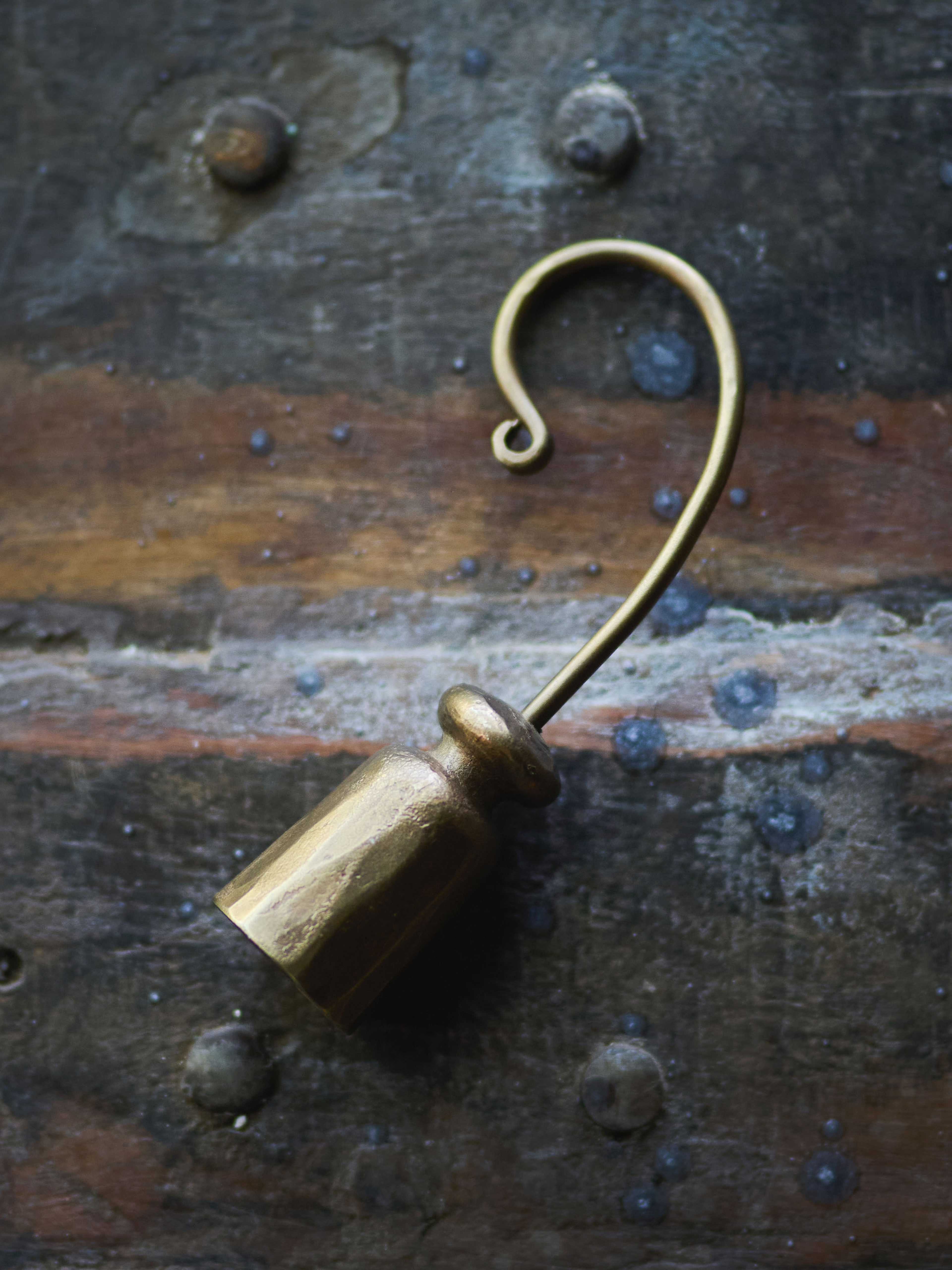 vintage style candle snuffer on a rustic metal surface for vintage home styling