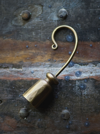 vintage style candle snuffer on a rustic metal surface for vintage home styling