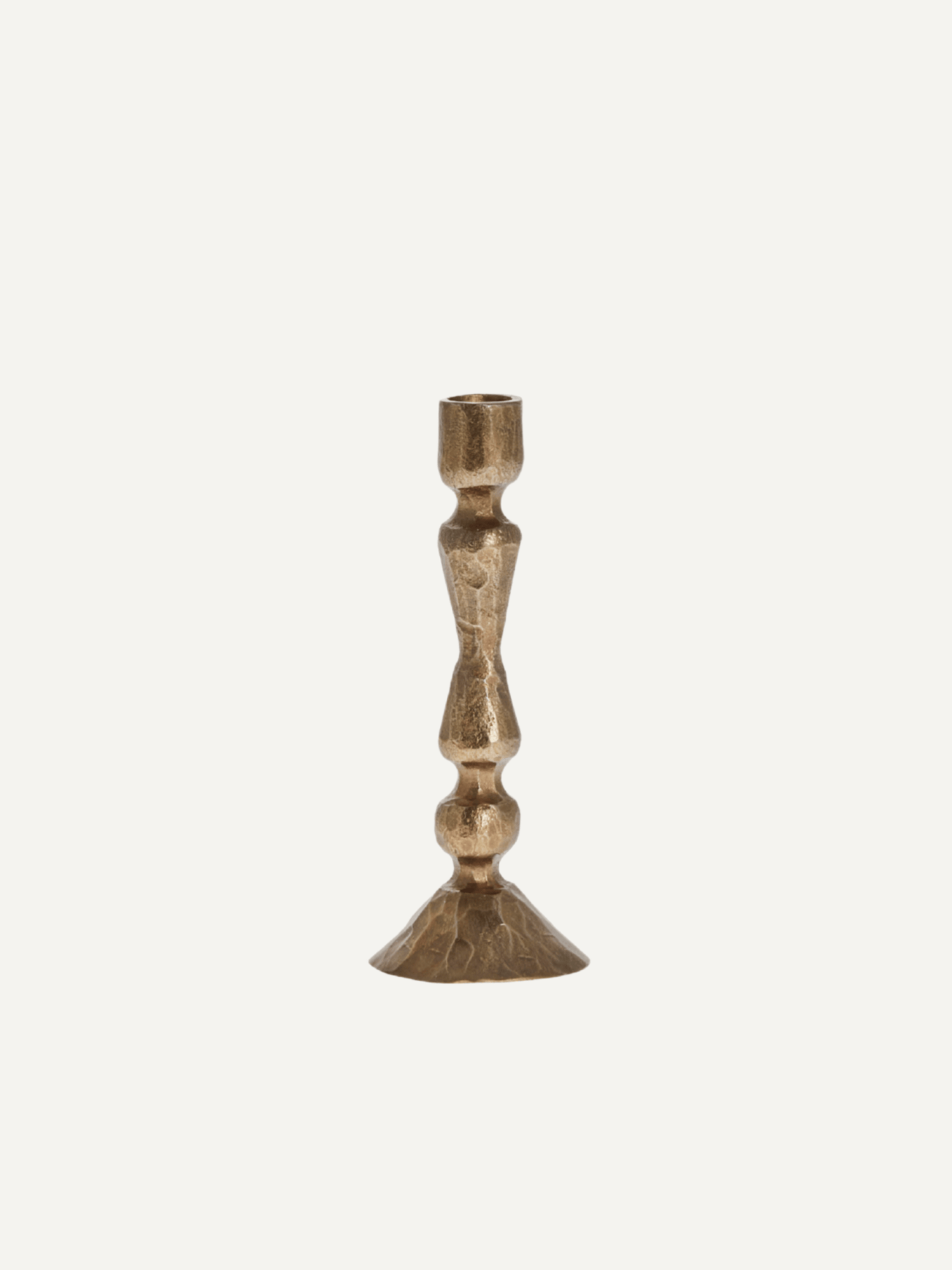 Metal vintage inspired timeless gold candle stick with a black base on a white background