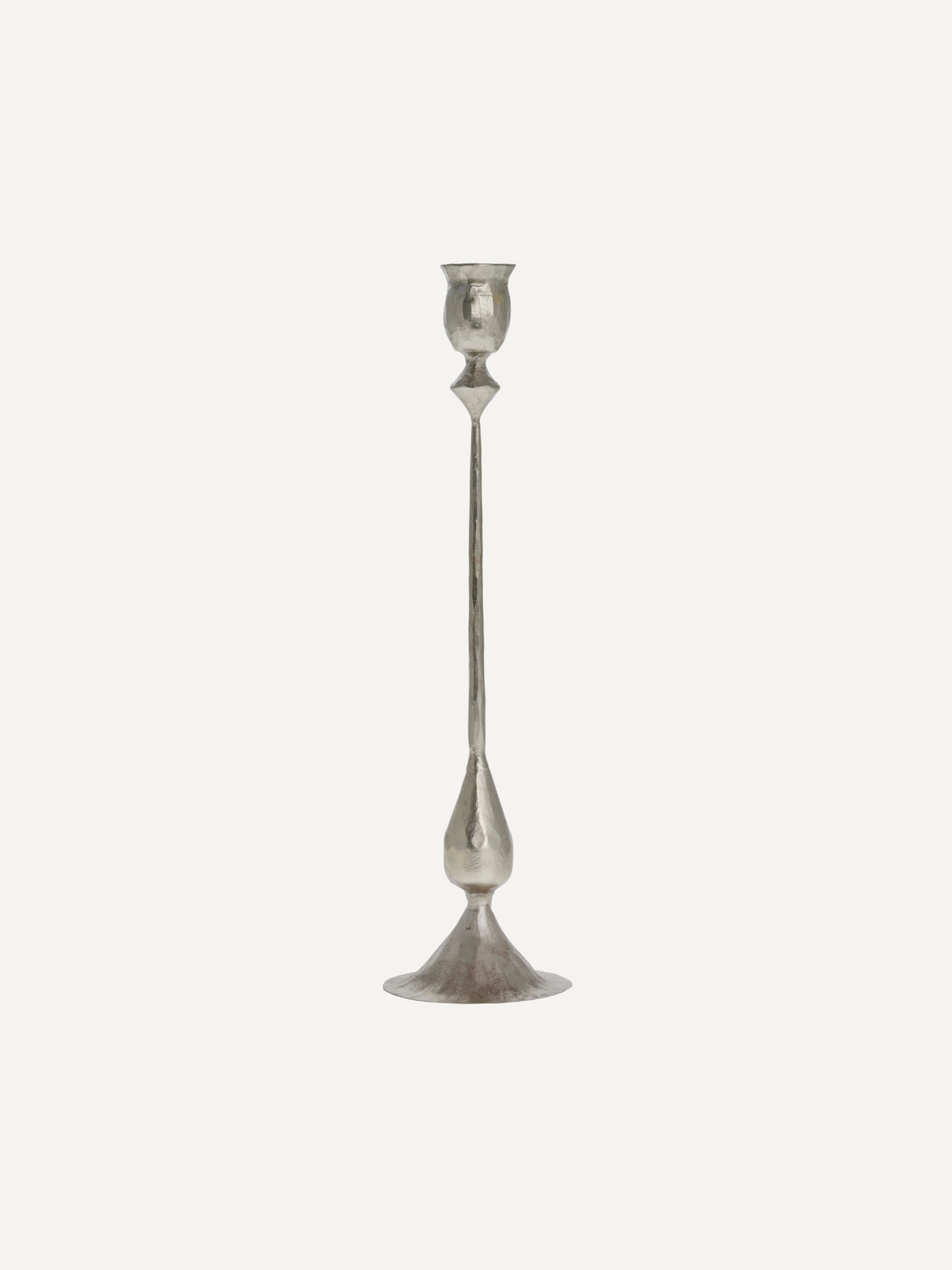 Silver metal vintage style candlestick on a light gray background