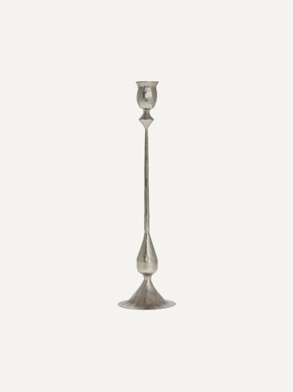 Silver metal vintage style candlestick on a light gray background