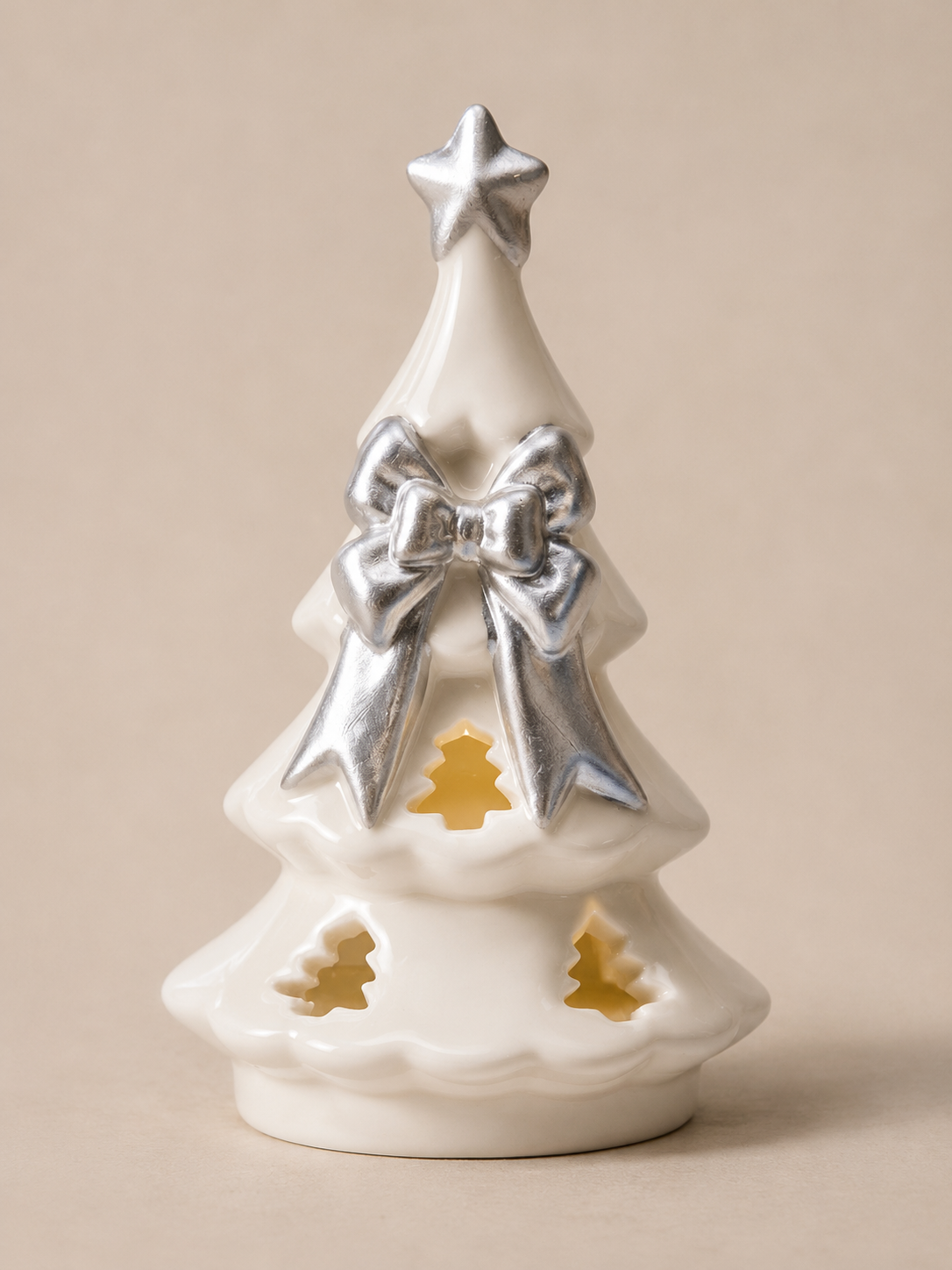 white ceramic christmas tree with silver bow
