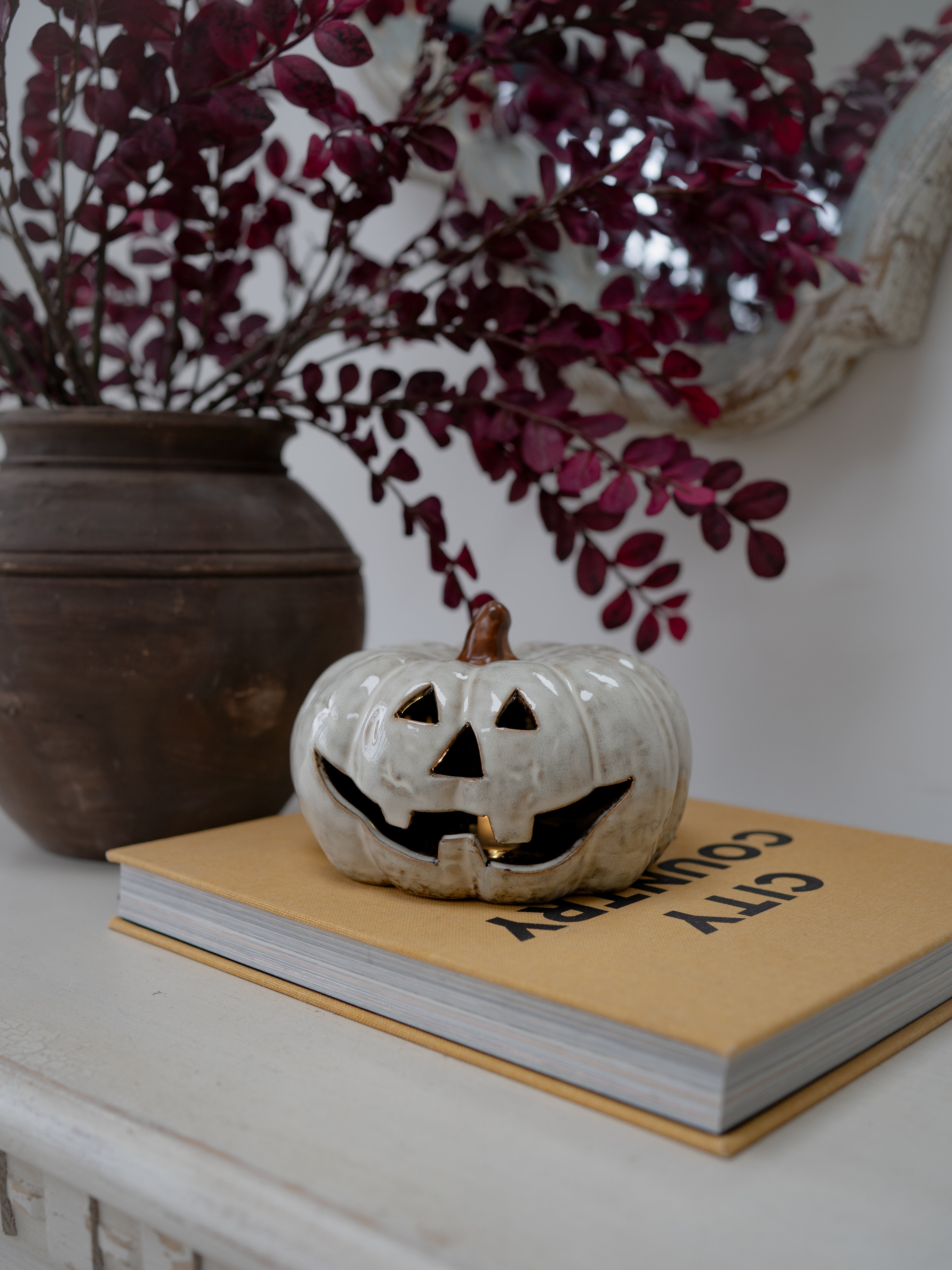 A small white ceramic jack-o&
