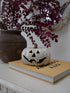 A small white ceramic jack-o&