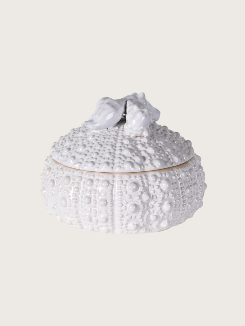 Decorative white box with textured surface and bow on a light gray background