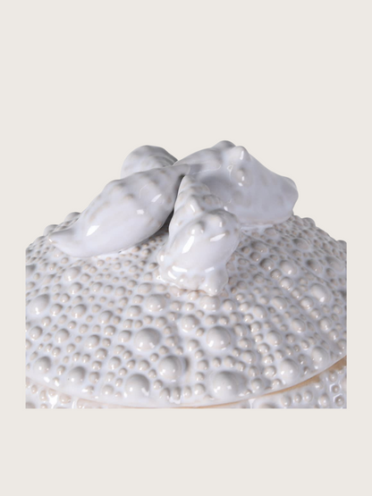Decorative ceramic piece with two seashells on a textured base