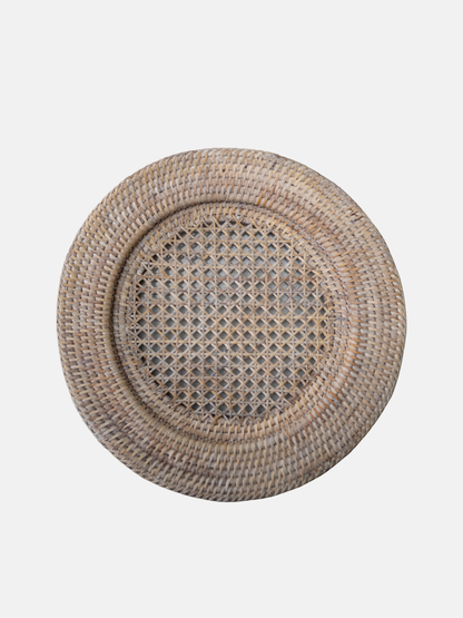 Round woven placemat with a textured pattern on a light gray background
