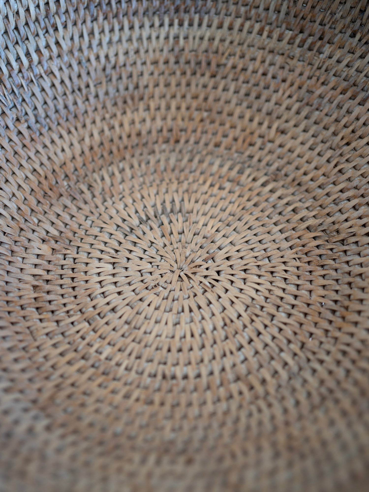Close-up of a woven rattan pedestal  fruit bowl texture