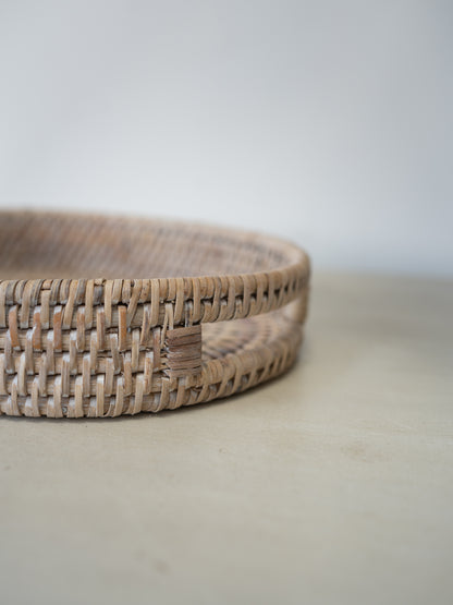 up close of cutout handle detail on white washed rattan tray
