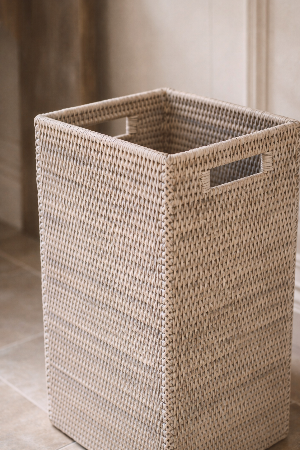 Woven umbrella basket on a tiled floor
