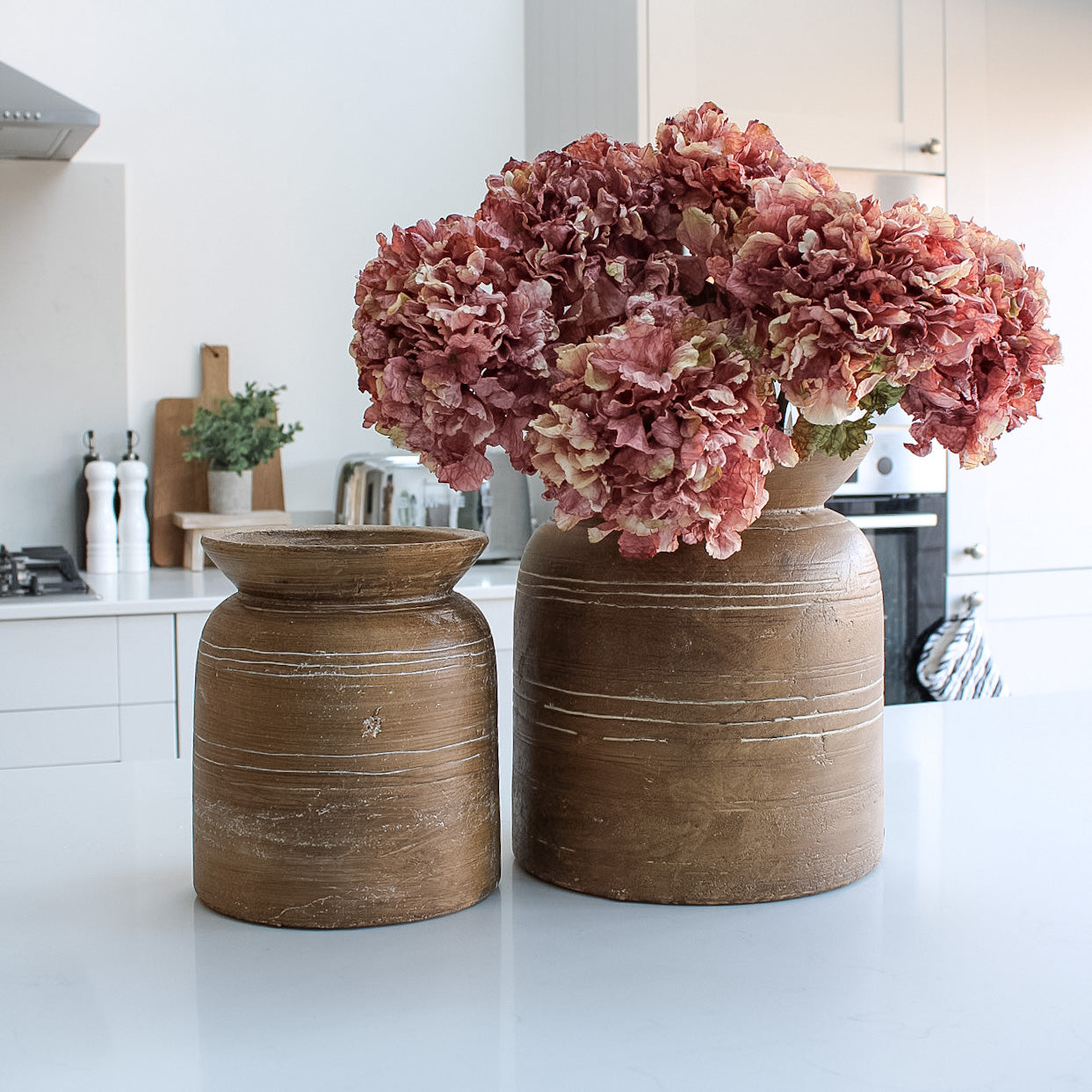 faux pink dried hydrangeas in rustic brown vase